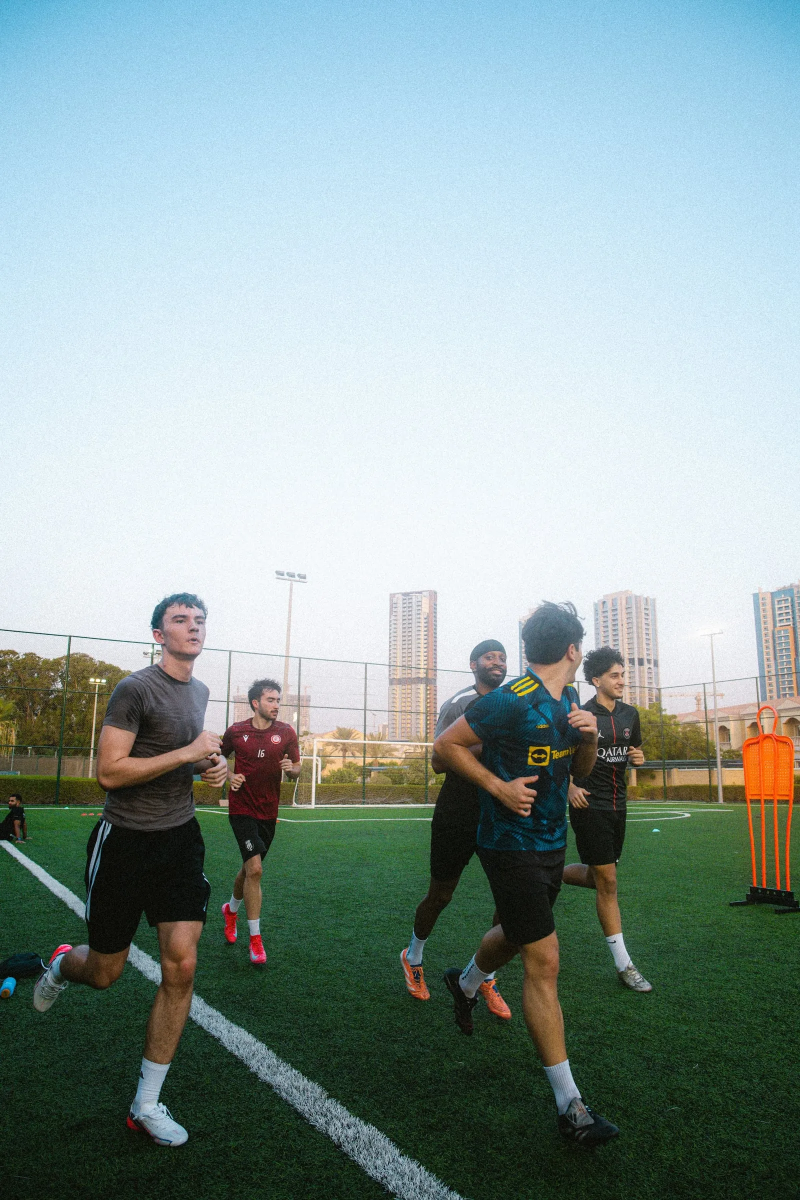 Players running through a warm-up at a Hulley Performance group session